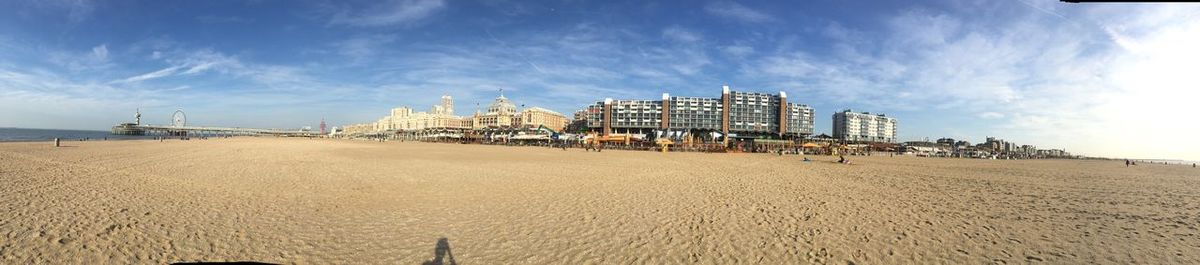 Panoramic view of beach and buildings against sky