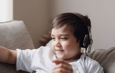 Portrait of boy using mobile phone at home