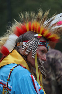 Portrait of man wearing feathers