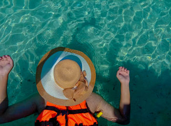 High angle view of man relaxing in swimming pool
