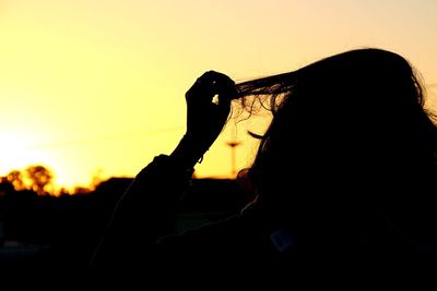 Silhouette man working against sky during sunset