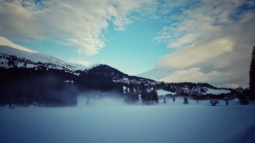 Scenic view of snow covered mountains against sky