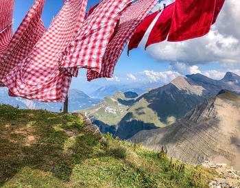 Scenic view of checkered laundry air drying against sky