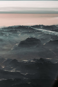 Scenic view of snowcapped mountains against sky during sunset