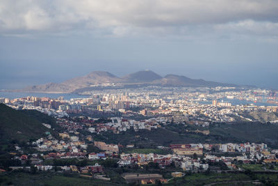 Aerial view of cityscape against sky