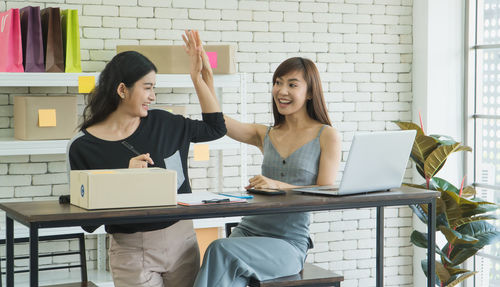 Young woman using mobile phone in office