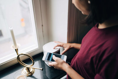 Midsection of woman using mobile phone