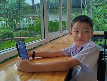 Portrait of boy in glass window