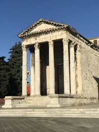 Low angle view of historical building against blue sky