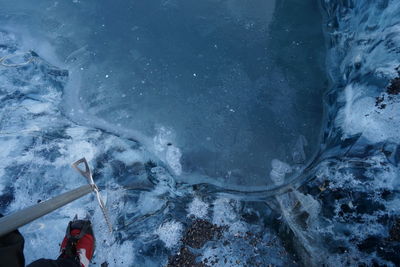 Low section of person on frozen lake