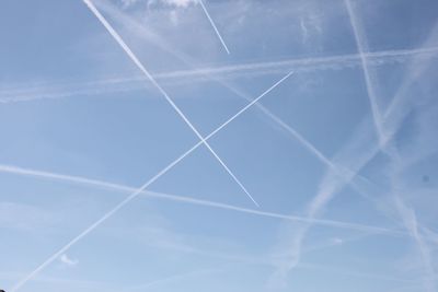 Low angle view of vapor trail in blue sky
