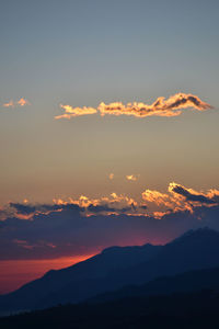 Scenic view of silhouette mountains against romantic sky at sunset