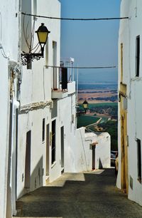 Street amidst white buildings against sky