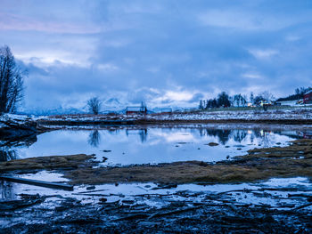 Scenic view of lake against sky during winter