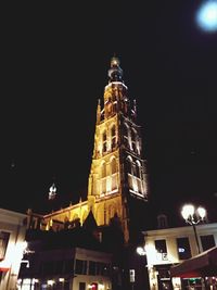 Low angle view of illuminated tower at night