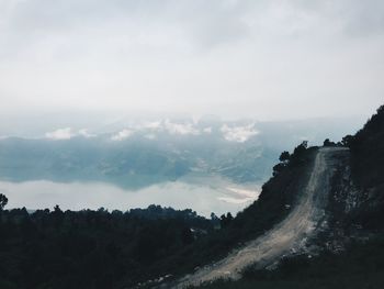 Scenic view of mountains against cloudy sky