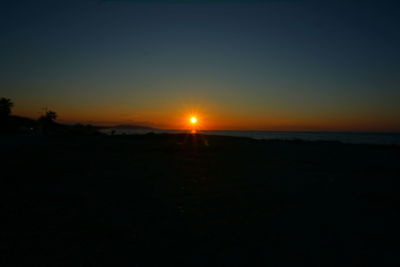 Scenic view of silhouette landscape against clear sky during sunset