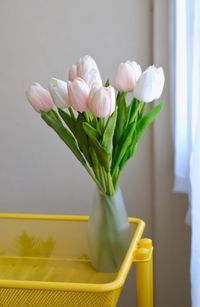 Close-up of white roses in vase on table