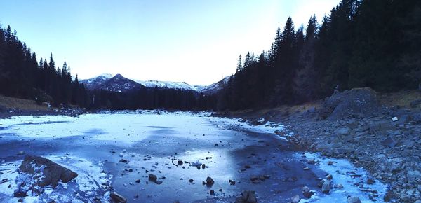 Scenic view of snow covered mountains against clear sky