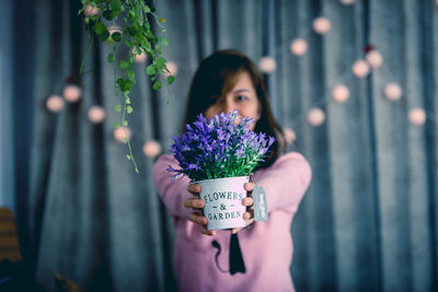 Woman holding purple flower