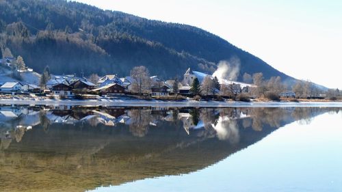 Scenic view of lake against sky during winter