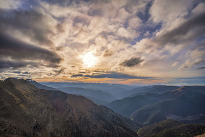 Scenic view of dramatic landscape against sky during sunset