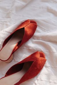 High angle view of shoes on bed at home