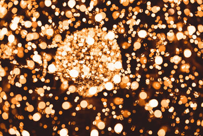 Defocused image of illuminated christmas lights at night