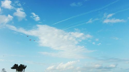 Low angle view of vapor trail against blue sky