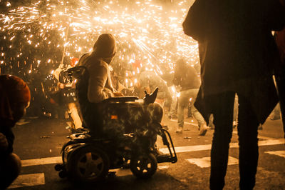 People riding motorcycle on road at night