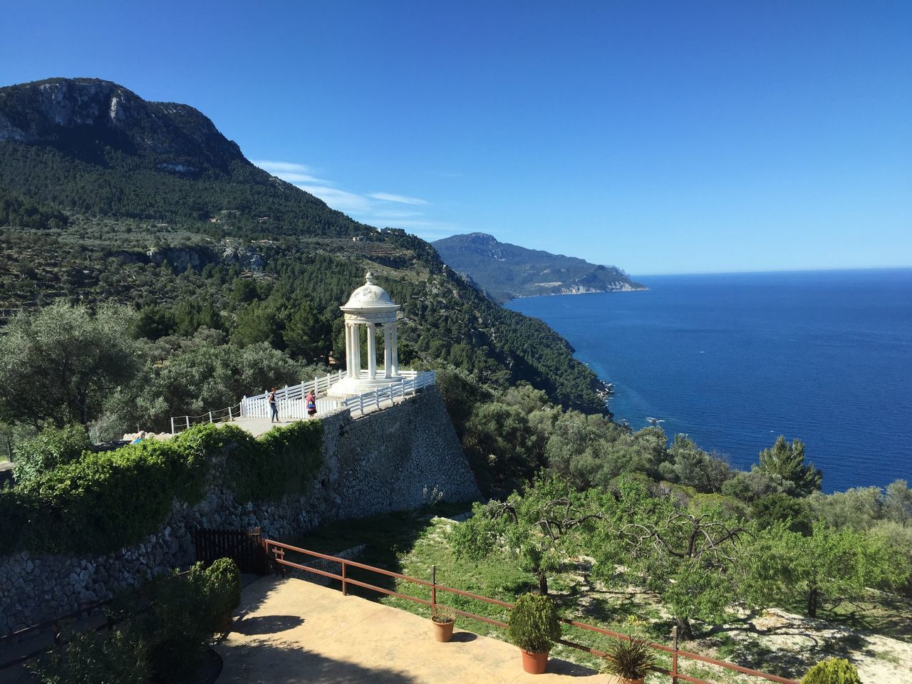 mountain, clear sky, sea, built structure, tranquil scene, scenics, tranquility, architecture, beauty in nature, building exterior, nature, blue, water, religion, mountain range, copy space, tree, guidance, spirituality