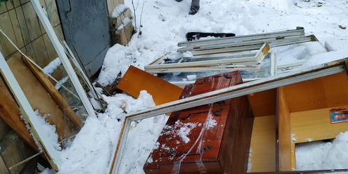 High angle view of abandoned building on snow covered field