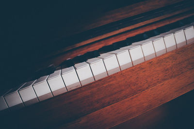 High angle view of piano keys on table against black background