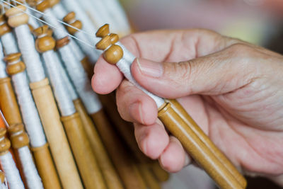 Close-up of human hand holding wood