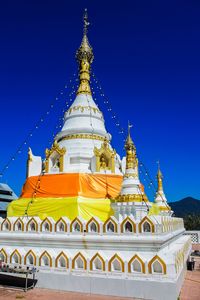 Temple against blue sky and building