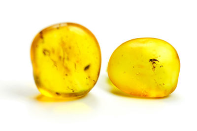 Close-up of yellow slices over white background