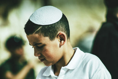 Close-up portrait of young man wearing hat