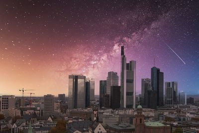 Aerial view of city against sky at night