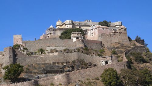 Low angle view of historical building against clear blue sky