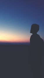 Silhouette of man standing on beach