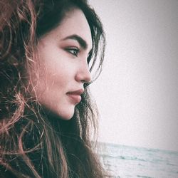 Close-up of beautiful young woman over white background