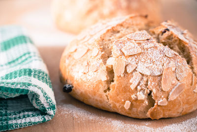 Freshly baked, homemade sweet cake with almonds and raisins on wooden board. easter loaf. 