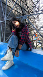 Portrait of woman sitting on snow