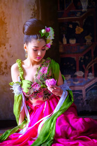 Close-up of young woman with flower bouquet