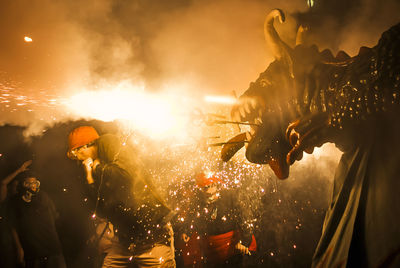 People wearing masks at dragon festival during night