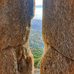 Close-up of rock formation in sea against sky