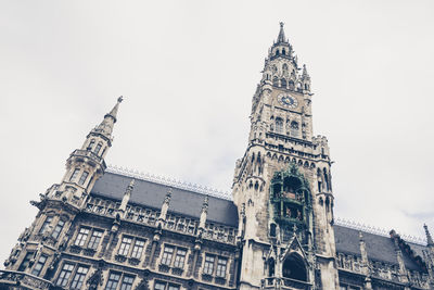 Low angle view of clock tower against sky in city