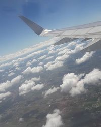 Cropped image of airplane flying over landscape