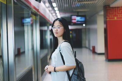 Side view of woman in eyeglasses standing in nanjing university of science and technology