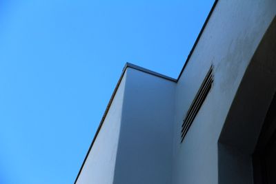 Low angle view of building against clear blue sky